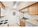 Efficient kitchen layout with modern appliances and ample cabinet space for convenient cooking at 10293 E Peakview Ave # F104, Englewood, CO 80111
