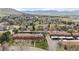 A beautiful aerial view of a community with charming townhomes, mature trees, and mountain views at 63 S Holman Way, Golden, CO 80401