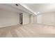 Finished basement area featuring neutral carpet, white door, drop ceiling, and staircase at 63 S Holman Way, Golden, CO 80401