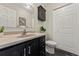 Bright bathroom featuring a sink, vanity, and toilet with tile floors and a wall cabinet at 63 S Holman Way, Golden, CO 80401
