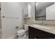 Well-lit bathroom featuring a vanity with granite top, toilet, and storage cabinet at 63 S Holman Way, Golden, CO 80401