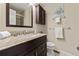 Charming bathroom featuring a vanity with granite counter, toilet, and decorative accents at 63 S Holman Way, Golden, CO 80401