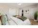 Bedroom featuring a bed with decorative pillows, neutral walls, and closet with white doors at 63 S Holman Way, Golden, CO 80401