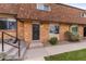 Charming brick townhome featuring a well-maintained walkway and front yard landscaping at 63 S Holman Way, Golden, CO 80401