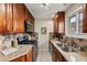 Kitchen features granite counters, stainless steel appliances, and wood cabinets at 63 S Holman Way, Golden, CO 80401