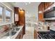 Kitchen boasts granite countertops, wooden cabinets and stainless steel sink at 63 S Holman Way, Golden, CO 80401