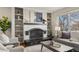 Cozy living room with a fireplace and built-in bookshelves at 63 S Holman Way, Golden, CO 80401