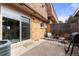 Cozy brick patio with sliding glass door, outdoor seating, and a grill at 63 S Holman Way, Golden, CO 80401