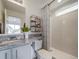 Bathroom with granite vanity, geometric shower curtain, and shower at 10306 Uvalda Ct, Commerce City, CO 80022