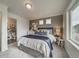 Bedroom with gray accent wall and plush bedding at 10306 Uvalda Ct, Commerce City, CO 80022