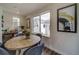 Bright dining area with wooden table and view to backyard at 10306 Uvalda Ct, Commerce City, CO 80022