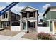 Two-story craftsman style home with gray siding, white trim, and landscaping at 10306 Uvalda Ct, Commerce City, CO 80022