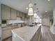 Modern kitchen with granite countertops and gray cabinets at 10306 Uvalda Ct, Commerce City, CO 80022