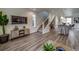 Open concept living area with kitchen and staircase view at 10306 Uvalda Ct, Commerce City, CO 80022