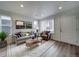 Spacious living room with gray sofa and stylish coffee table at 10306 Uvalda Ct, Commerce City, CO 80022