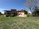 Expansive backyard featuring a spacious deck and a lush green lawn at 2100 Robb St, Lakewood, CO 80215