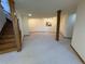 Spacious carpeted basement featuring recessed lighting, stairs, and a decorative support column at 2100 Robb St, Lakewood, CO 80215