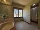 Bathroom with tile flooring, double sinks, large windows, and separate shower area at 2100 Robb St, Lakewood, CO 80215