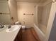 Bathroom featuring vanity sink, toilet, and a tub and shower combination with tile surround at 2100 Robb St, Lakewood, CO 80215