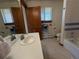 Well-lit bathroom featuring a single sink, mirror, and tile flooring at 2100 Robb St, Lakewood, CO 80215