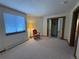 Bedroom featuring carpeted flooring, a window, and a closet with mirrored doors at 2100 Robb St, Lakewood, CO 80215