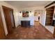 Inviting entry features striking terra cotta floors, warm wood trim, and artful details that create a welcoming ambiance at 2100 Robb St, Lakewood, CO 80215