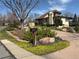 Charming home featuring a landscaped front yard, circular driveway, and a welcoming, covered porch at 2100 Robb St, Lakewood, CO 80215