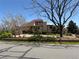 Well-maintained home featuring mature trees and manicured landscaping at 2100 Robb St, Lakewood, CO 80215