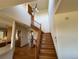 Inviting foyer featuring hardwood floors, staircase, and modern lighting fixture at 2100 Robb St, Lakewood, CO 80215