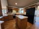 Updated kitchen featuring an island, modern appliances, ample counter space, and a delightful breakfast area at 2100 Robb St, Lakewood, CO 80215