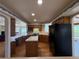 Well-appointed kitchen with wood cabinets, central island, modern appliances, and views to a sunny breakfast nook at 2100 Robb St, Lakewood, CO 80215