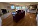 Cozy living room with hardwood floors, fireplace, plush seating, and views from windows and a sliding door at 2100 Robb St, Lakewood, CO 80215