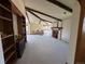 Spacious living room boasts exposed beams, a cozy fireplace, built-in shelving, and large windows for natural light at 2100 Robb St, Lakewood, CO 80215