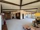 Expansive living room with exposed beams, built-in bookshelves, fireplace, and plush carpet for ultimate relaxation at 2100 Robb St, Lakewood, CO 80215