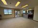 Open concept living room with fireplace, large window, and access to the kitchen at 2100 Robb St, Lakewood, CO 80215