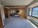 Spacious main bedroom with hardwood beam and natural light from the large windows at 2100 Robb St, Lakewood, CO 80215