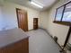 Functional utility room with cabinets, sink, and a window at 2100 Robb St, Lakewood, CO 80215