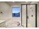 Modern bathroom featuring a soaking tub and walk-in shower at 8512 Orchard City Dr, Littleton, CO 80125