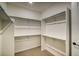 Spacious walk-in closet with ample shelving and hanging rods at 8512 Orchard City Dr, Littleton, CO 80125
