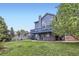 Exterior of a two-story home with a deck, patio, and grassy backyard at 1663 E 96Th Pl, Thornton, CO 80229