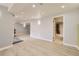 Spacious basement with light wood flooring, recessed lights, and a bathroom through the door at 1663 E 96Th Pl, Thornton, CO 80229