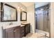 Bathroom featuring a walk-in shower and double vanity at 1663 E 96Th Pl, Thornton, CO 80229