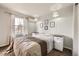 Inviting bedroom featuring a cozy bed and a large window for ample natural light at 1663 E 96Th Pl, Thornton, CO 80229