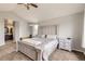 Bright bedroom with vaulted ceilings, a large bed, with a view to an ensuite bathroom and cozy carpeted floors at 1663 E 96Th Pl, Thornton, CO 80229
