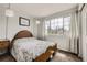 Inviting bedroom featuring a cozy bed and a large window for ample natural light at 1663 E 96Th Pl, Thornton, CO 80229