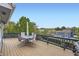 Spacious wood deck with patio table, seating, and scenic backyard views at 1663 E 96Th Pl, Thornton, CO 80229