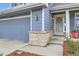 Close-up of the home's entrance, showing a two-car garage, brick accents, and decorative details at 1663 E 96Th Pl, Thornton, CO 80229