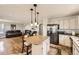 Open kitchen and living area with a center island, stainless steel appliances, and a seamless flow at 1663 E 96Th Pl, Thornton, CO 80229