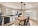 Well-lit kitchen featuring a center island, granite countertops, and modern appliances at 1663 E 96Th Pl, Thornton, CO 80229