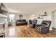 Inviting living room features hardwood floors, comfortable seating, and an abundance of natural light at 1663 E 96Th Pl, Thornton, CO 80229